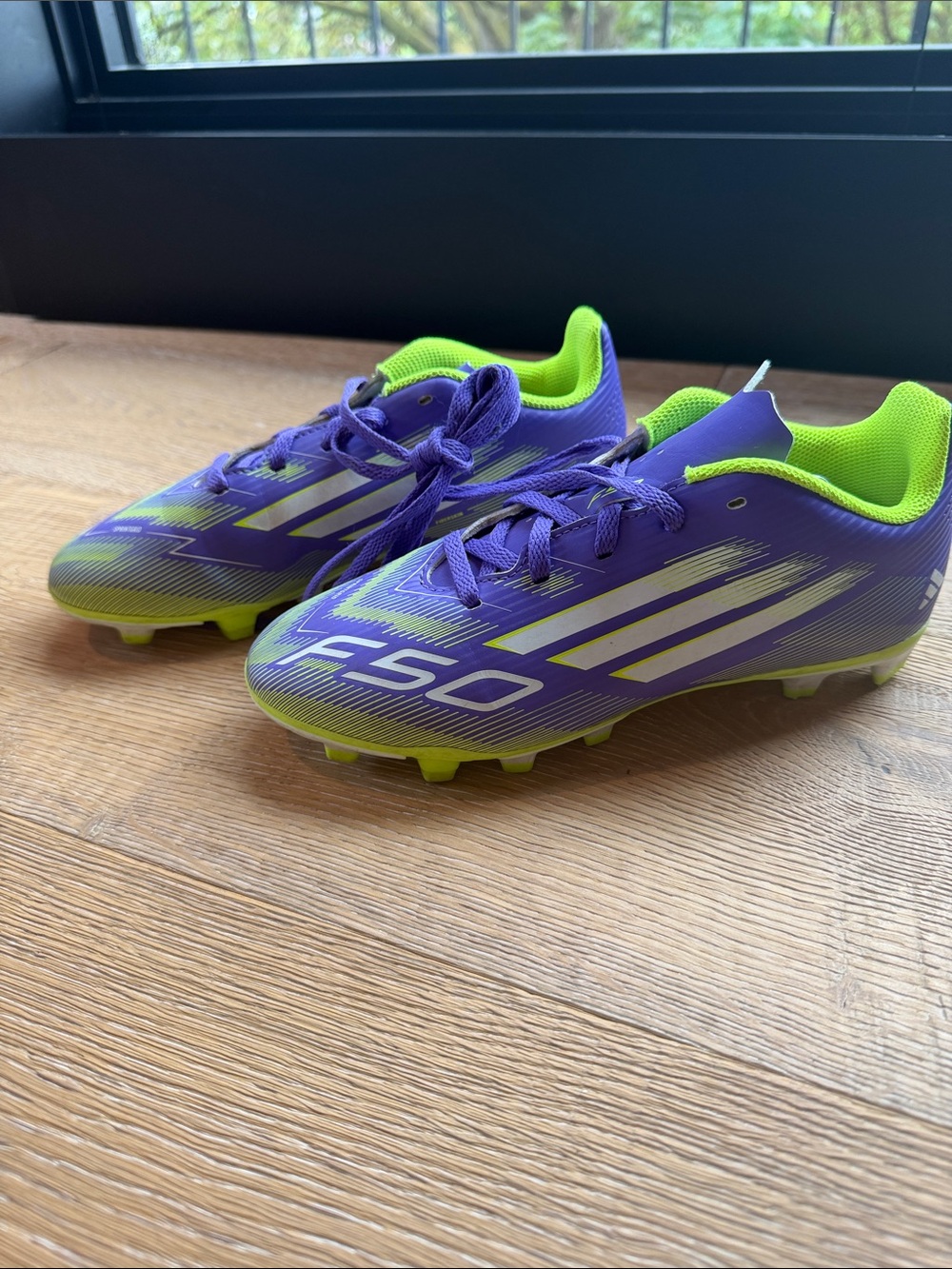 Gently used; adidas Purple and Neon Green Kids Soccer Cleats